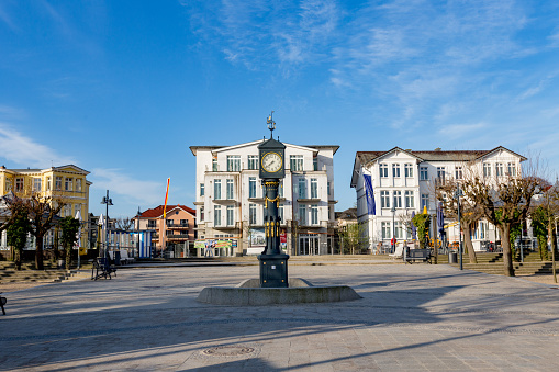 Ahlbeck, Germany - April 17, 2014: old clock tower at the scenic promenade with historic in wilhelminian style hotels in Ahlbeck, Germany.