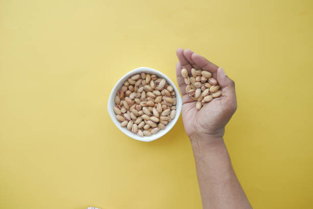 istock top view of pistachios nuts on hand 1644356924