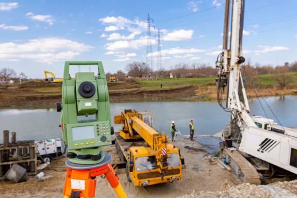 istock Total station in front of Mobile crane and drilling machine working together on bridge foundation 1644361217