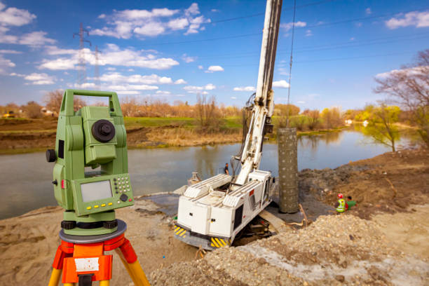 istock Total station in front of Mobile crane and drilling machine working together on bridge foundation 1644363421