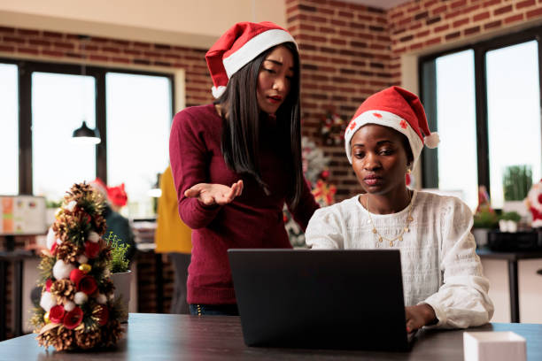 istock Women in christmas decorated office 1644371961
