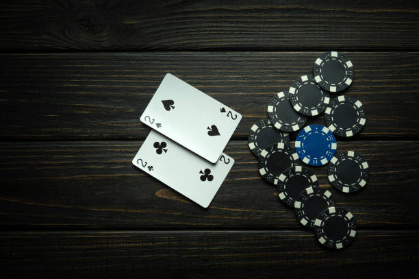 istock Gambling poker game with one pair combination. Chips and cards on a black vintage table in a poker club. Free black space for ads 1644377061