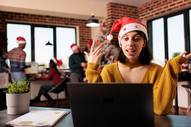 istock Manager in santa hat attending videocall 1644383883