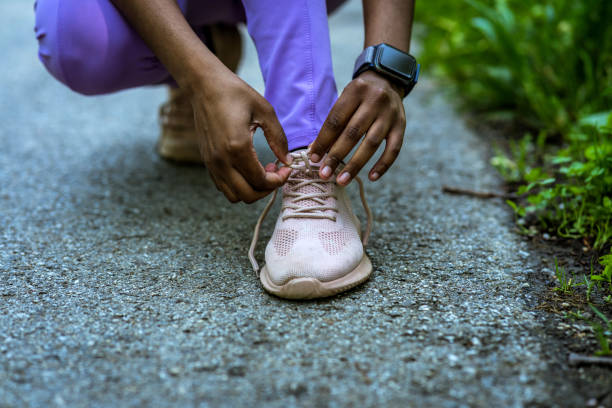Shot of a sporty young woman tying her shoelaces before her run.