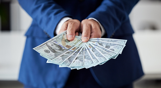 Hands, businessman and money fan of dollars for finance, trading bills and investment reward of financial freedom. Closeup of rich trader, profit and income of bonus, pay cash or accounting of wealth