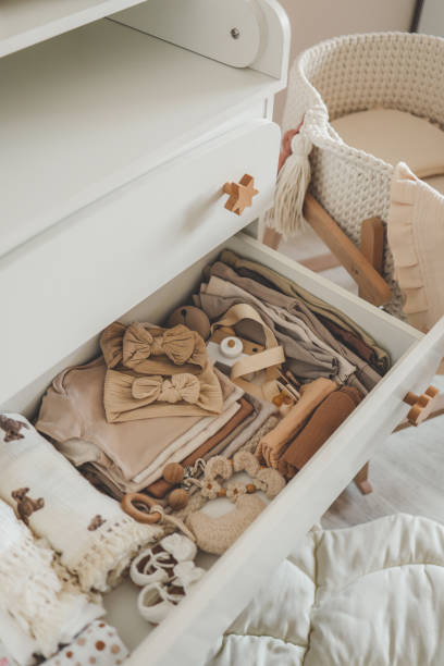 istock Dresser with clothes for a newborn, organizing storage 1644394438