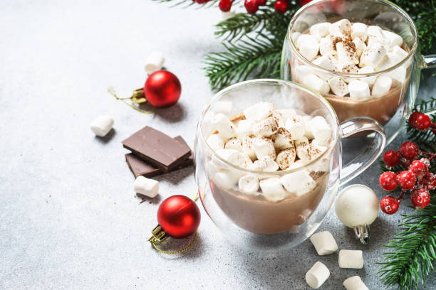 istock Christmas hot chocolate or cocoa with marshmallow on white with christmas decorations. 1644394591