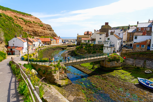 Cowbar, England - 24 May 2023: Tourists and locals enjoy the spring sunshine in the coastal villages of Cowbar and Staihes.