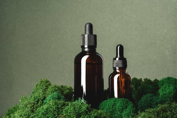 istock Vape smoking liquid bottles on moss background 1644395167