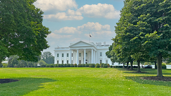 The White House with its trees and surrounding lawn.