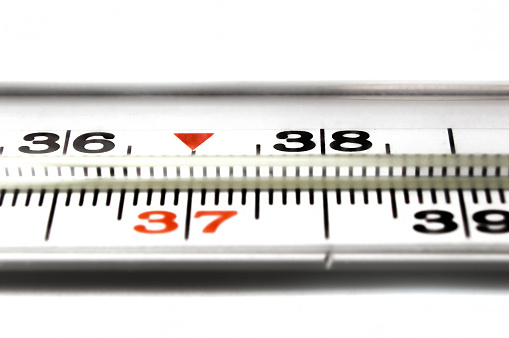Thermometer closeup on white background. Closeup photo of medical preparations.