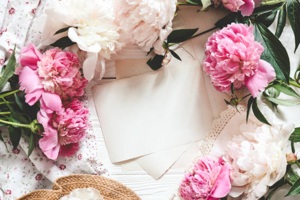 istock Letter template with place for your text and peonies, top view 1644395967