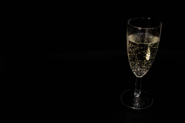istock Champagne glass on black background 1644398279