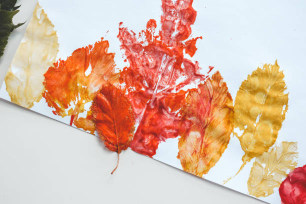 istock Children's autumn activity, leaf print on paper 1644416231