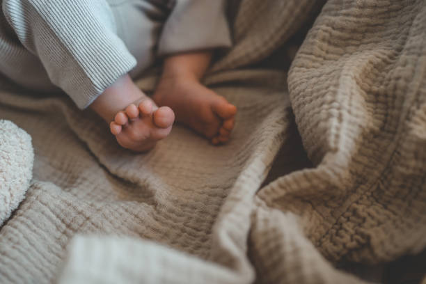 istock Feet of a newborn baby in a cradle close-up 1644417841