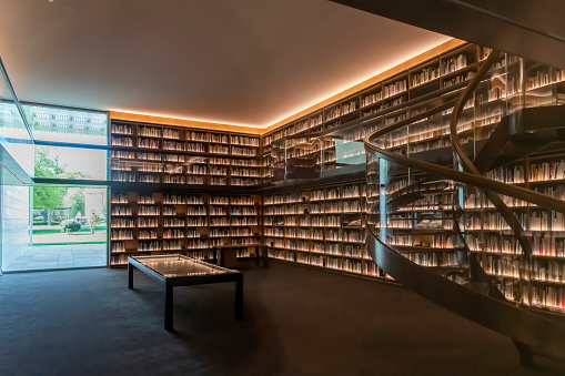 Wassenaar, The Netherlands-May 2022; Interior view of the library with glass circular stairs and window on garden in private Art Museum Voorlinden founded and owned by Joop van Caldenborgh