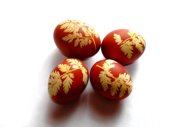 istock Painted Easter eggs on a white background. Floral pattern on a red eggshell. Festive food. 1644424622