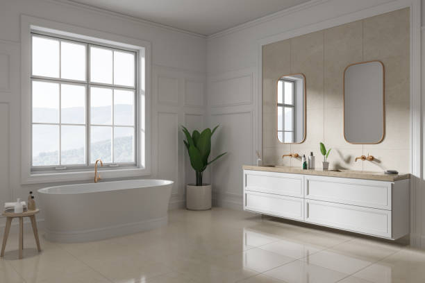 istock Classic hotel bathroom interior with bathtub and double sink, window 1644436830