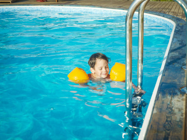 istock A Beautiful boy swims alone in the pool. 1644442598