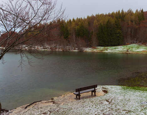 A bench with a mountain and sea view