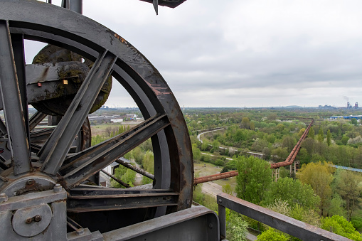 Panoramic view from the top of an abandoned blast furnace with wheel in an old ironworks factory in Landschaftspark Duisburg, Germany