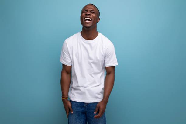 istock positive handsome dark-skinned young american guy in white t-shirt 1644457470