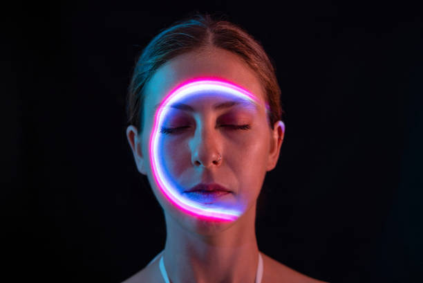 istock Pink circle of light on woman's face 1644466023