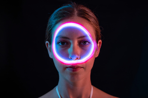 Pink circle of light on woman's face.