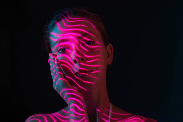 istock Purple neon lights on woman's face 1644466680