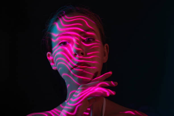 istock Purple neon lights on woman's face 1644466689