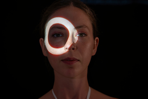 Circle of light on womans face.