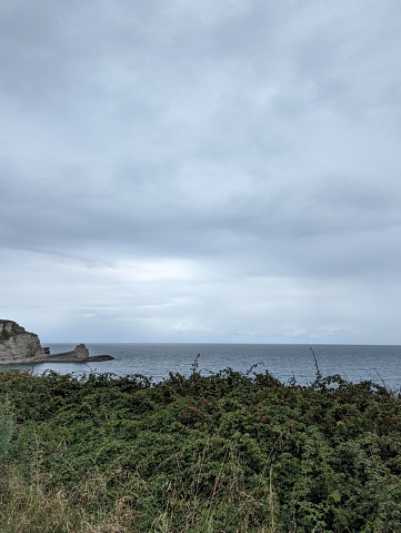 A scenic view of the Langreo coast in Cantabria on a cloudy day