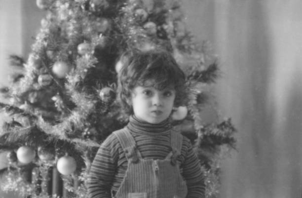 istock Little Boy under Christmas Tree in 1964. 1644484470