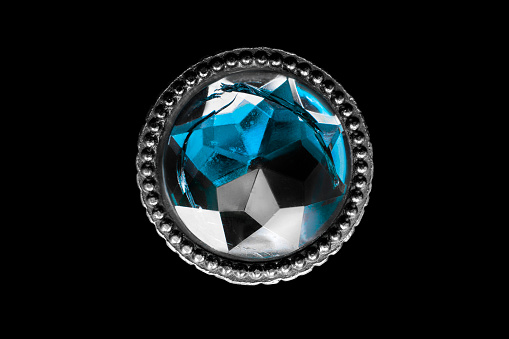Vintage blue crystal button isolated on black background