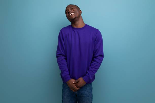 istock well-groomed friendly young african man in a blue sweater on a blue background with copy space 1644486869
