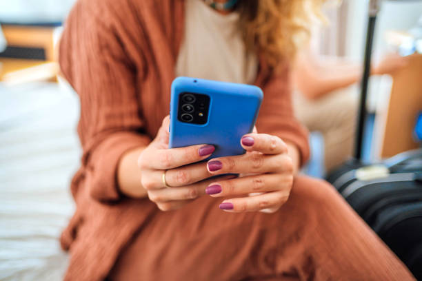 istock Woman using a smartphone in a hotel room 1644486960