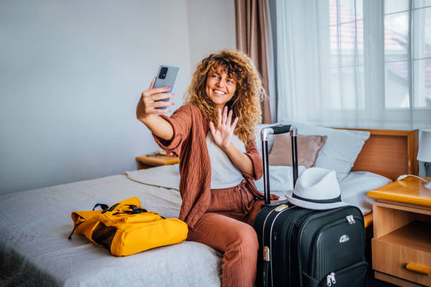istock Woman having a video call in a hotel room 1644486975