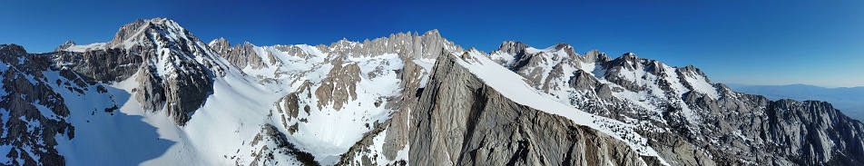 A panoramic of mount Whitney, California showing the snow capped peaks