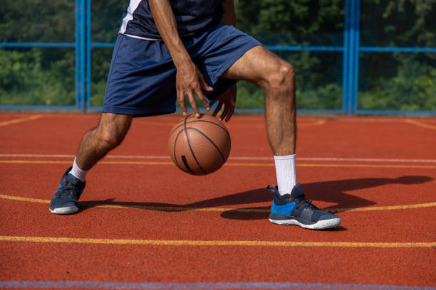 istock Unrecognizable man playing basketball at court. 1644495775