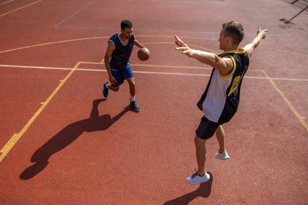 istock Two athletes playing basketball outdoors. 1644495782