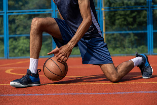 istock Unrecognizable man playing basketball at court. 1644495783