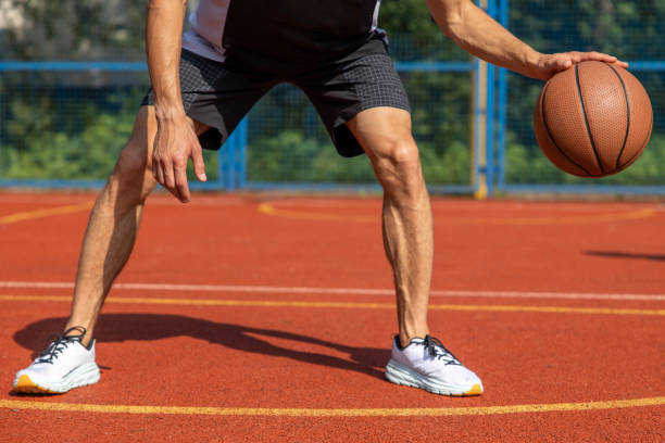 istock Unrecognizable man playing basketball at court. 1644497848