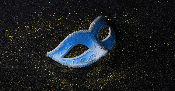 blue masquerade eye mask isolated on black background