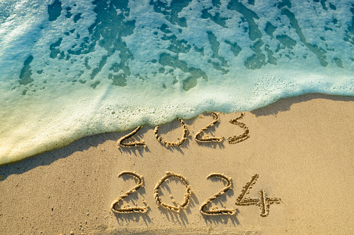 New Year 2024 replace 2023 on the beach.