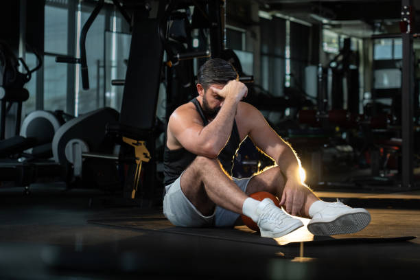 istock depress athletic caucasian man after practicing routine weightlifting and overtraining at modern gym 1644530247
