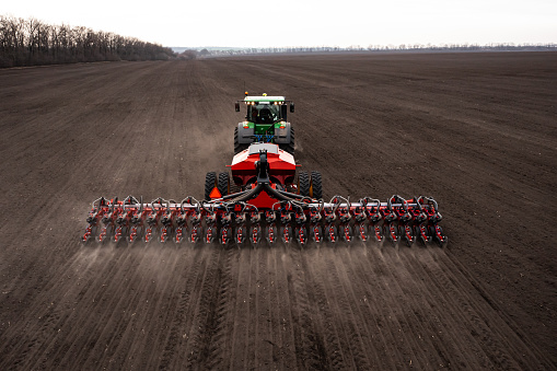 Ukraine, Kyiv region, 12.04.2021. Tractor plows the field, plowed land, harvest 2023.