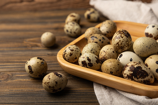 Quail eggs on a  texture background.Organic food. Place for text. Fresh quail eggs.