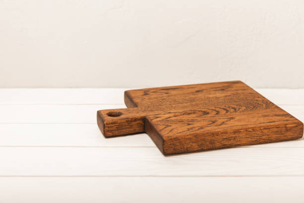 istock Cutting board and kitchen appliances on wall background.Modern kitchen background with kitchen utensils standing on wooden tabletop, blank space for text, front view.Recipe.MOCKUP.Cooking concept 1644559830