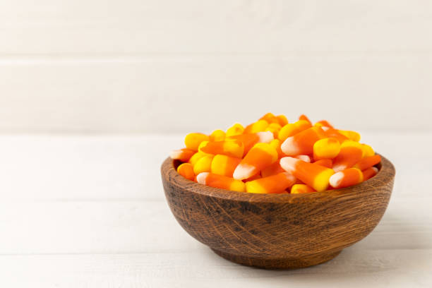 istock Halloween candy corn,jelly eye, pumpkin candy, sugar skull in different bowls on  background.Classic candy sweets for Halloween with.Halloween holiday concept with candy corn and jack o lantern. 1644560912