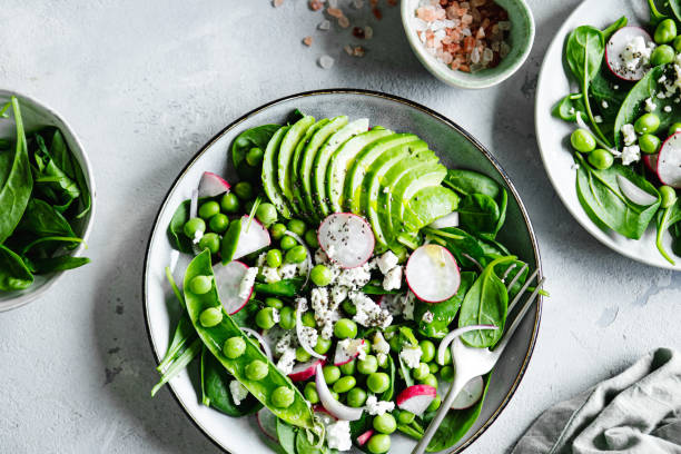 istock Plate of healthy green salad on white table 1644564117